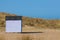 Striped beach hut on sandy beach. Secluded beach vacation.