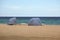 Striped beach shelters on Dania Beach