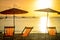 Striped beachchairs and sunshade at sunset