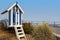 Striped blue beach hut on Filey promenade