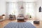 Striped carpet and pink lamp in teenager room interior with bed next to desk and chair