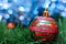 Striped christmas decoration ball in red and blue colors with pi