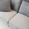 Striped cushion decorating a gray textile sofa