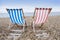 Striped deckchairs on pebble beach