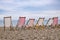 Striped deckchairs on pebble beach