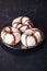 Striped donuts on dark wooden table in studio photo