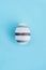 Striped egg on wooden background, Easter concept.