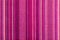 Striped fabric texture with multiple warm colors purple, purple, magenta, pink, red, maroon, orange, yellow.