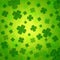 Striped four-leaved shamrocks in green old paper background