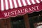 Striped french restaurant canopy in Paris france, menu board