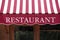 Striped french restaurant entrance canopy, Paris france.