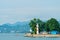 Striped lighthouse on the city shore, photograph