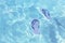 Striped marine flip flops floating in clear sea water