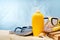 Striped marine flip flops, sunscreen lotion on a sandy beach