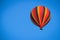 Striped multicolored balloon in a bright blue summer sky