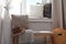 Striped plaid, hat and cushion on bench near window sill with pillows. Cozy place to relax