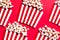 Striped Popcorn Bukcets on Red Background. Cinema and Movies Conccept. Flat Lay Box Officce Background
