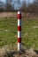 Striped red and white signal poles barricade