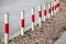 Striped red and white signal poles on roadside