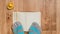 Striped socks with toes against a background of a book, a wooden floor, and a rubber duck.