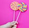 Striped spiral multi-color Lollipop closeup in hand