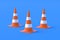 Striped traffic cones, barriers on blue background