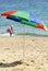 Striped umbrella on a sandy beach