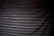 Striped window blind light on black backdrop