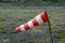 Striped windsock pouted from the wind at a local small airfield