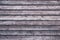 Striped wood surface. Grunge wooden fence. Shabby planks. Oak table with horizontal stripes. Dark board texture. Gray and brown lu