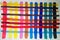Stripes of acrylic paint of different colors superimposed on each other.