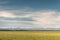 Stripes - grass on a background of snow-capped mountains and sky