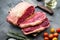 Striploin steak, raw beef butchery cut, on gray background