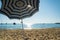 Stripped umbrella on a deserted beach