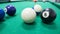 Strips and solds balls on green pool table