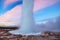 Strokkur geyser eruption in Iceland. Fantastic colors shine through the steam.