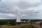 The Strokkur geyser in Iceland is erupting while tourists are looking. Strokkur, Iceland - 30 of July 2019: The Strokkur