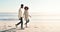 Strolls on the beach with my better half. Full length shot of an affectionate young couple taking a stroll on the beach