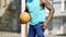 Strong Afro-American person flexing, preparing for basketball game, warming up