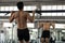 Strong Asian man pull up bar in gym