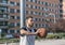 Strong athlete basketball player is leaning on a metal column with his ball