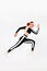 Strong athletic woman sprinter, running on white background wearing sportswears. Fitness and sport motivation. Runner