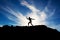 Strong beautiful man standing on the lava mountain with the blue sky on the background