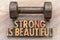 Strong is beautiful - word abstract in vintage wood type