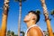 Strong brazilian man with a helathy body using spf cream in sunny day at beach