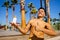 Strong brazilian man with a helathy body using spf cream in sunny day at beach