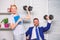 Strong business team. Healthy habits in office. Man and woman raise heavy dumbbells. Strong powerful business strategy