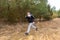 Strong caucasian teenage boy wearing sportswear running through a forest