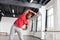 Strong dark-skinned man wearing comfortable bright outfit while working out