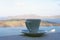 Strong delicious coffee in a white cup with a saucer against the backdrop of the sea and a floating liner. Great start to the day.